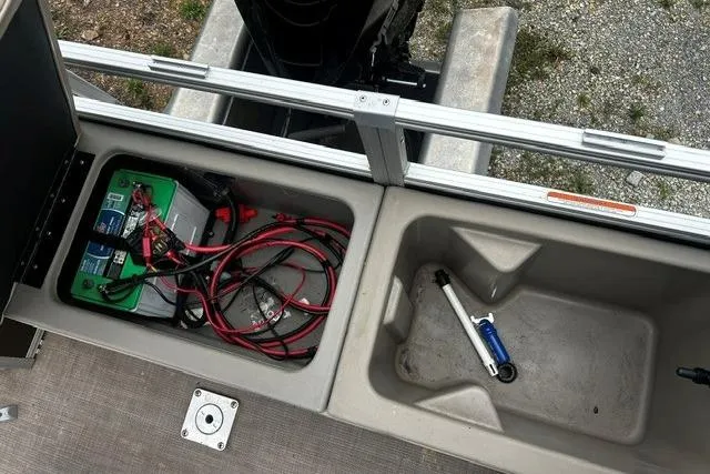 Slide: The Image of Battery compartment of 2020 Sun Tracker SportFish 22 XP3 with cables and tools. - 8