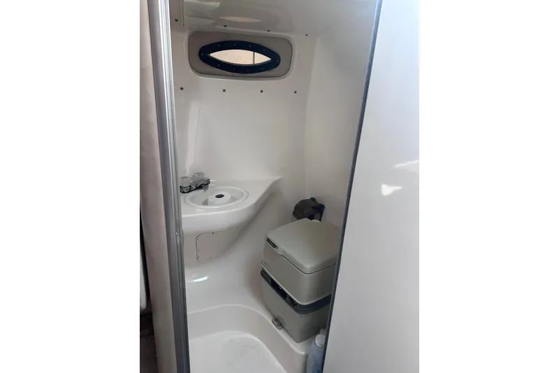 Slide: The Image of 1999 Chaparral Signature 240 boat bathroom with sink and portable toilet. - 15