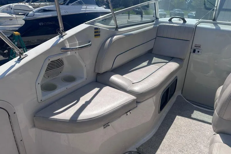 Slide: The Image of 1999 Chaparral Signature 240 boat interior with cushioned seating and cup holders. - 10