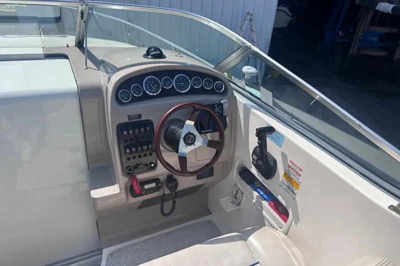 Slide: The Image of 1999 Chaparral Signature 240 boat dashboard with steering wheel and control panel. - 4