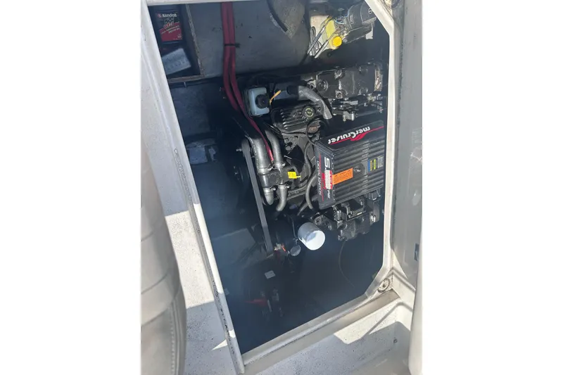 Slide: The Image of Engine compartment of a 1999 Chaparral Signature 240 boat, featuring a MerCruiser engine. - 23
