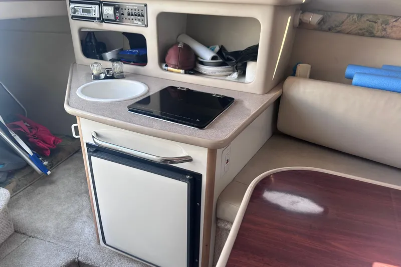 Slide: The Image of Interior of 1999 Chaparral Signature 240 boat with kitchenette and seating area. - 13