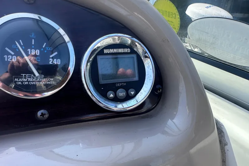 Slide: The Image of Dashboard of a 1999 Chaparral Signature 240 with temperature and depth gauges. - 17
