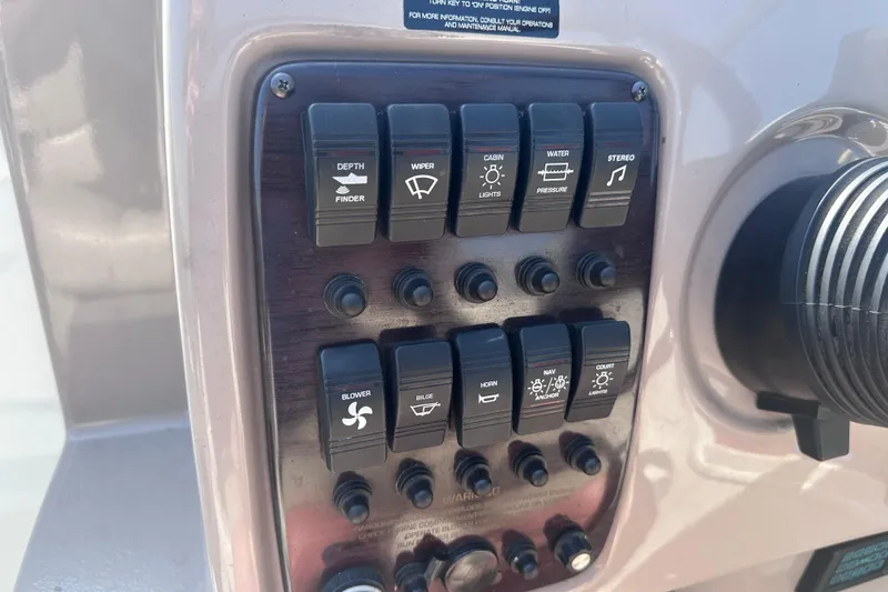 Slide: The Image of Control panel of a 1999 Chaparral Signature 240 boat with labeled switches. - 19