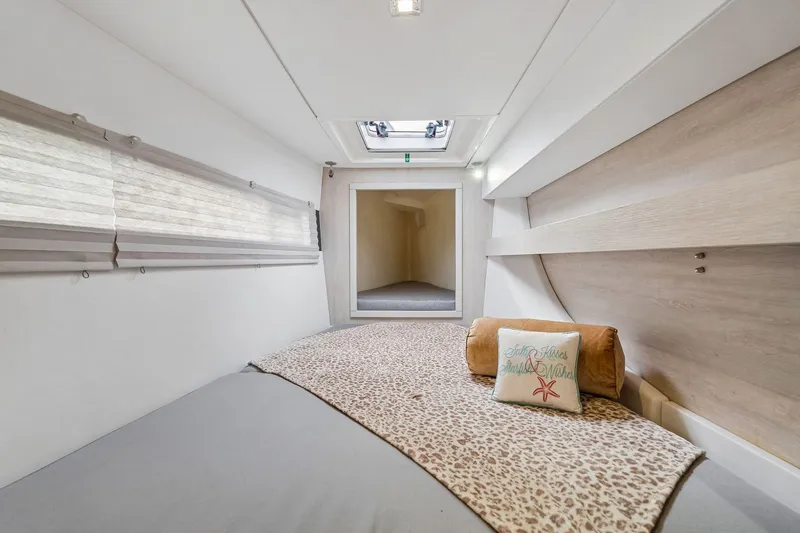 Slide: The Image of Cozy cabin interior of 2021 Leopard 43 Powercat with leopard print bedding and decorative pillows. - 40