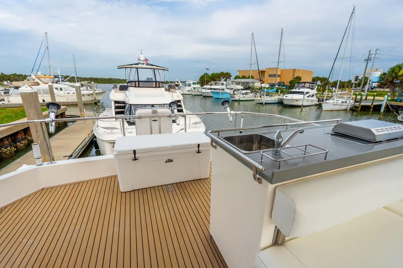 Slide: The Image of 2021 Leopard 43 Powercat yacht with outdoor sink and seating at marina. - 21