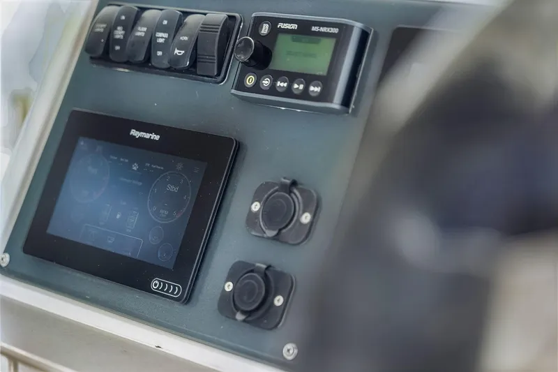 Slide: The Image of Control panel of a 2021 Leopard 43 Powercat featuring Raymarine and Fusion systems. - 16