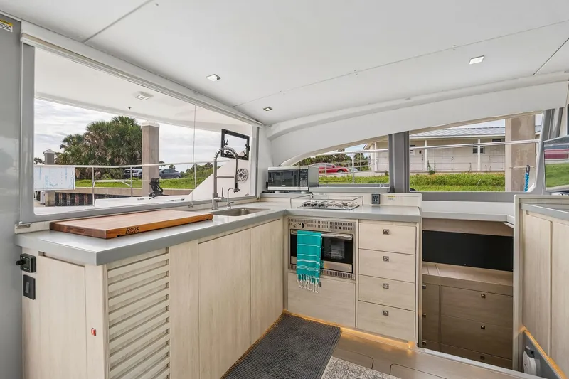 Slide: The Image of Modern kitchen interior on 2021 Leopard 43 Powercat yacht, featuring sleek cabinetry and appliances. - 26