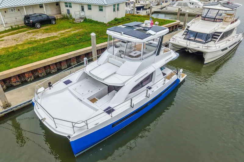 Slide: The Image of 2021 Leopard 43 Powercat yacht docked at marina, featuring sleek design and solar panels. - 46
