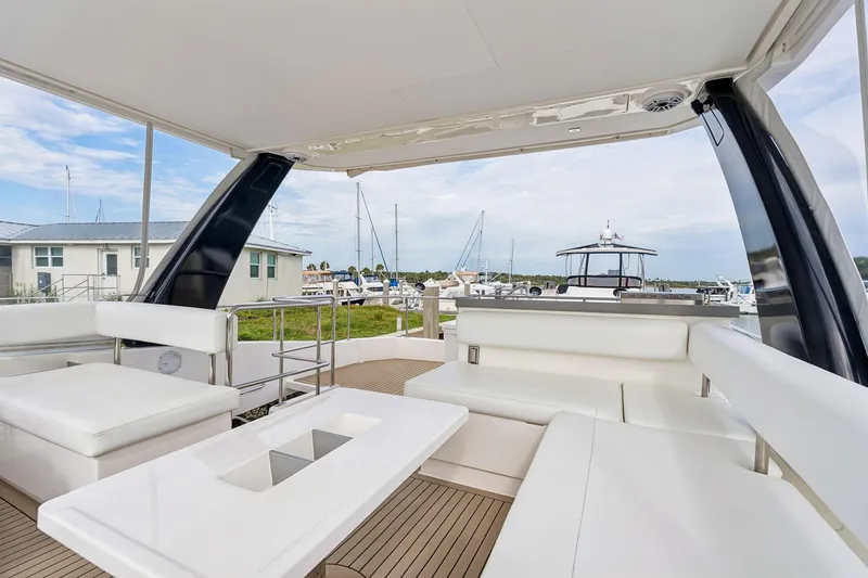 Slide: The Image of Luxurious 2021 Leopard 43 Powercat yacht interior with white seating and marina view. - 20