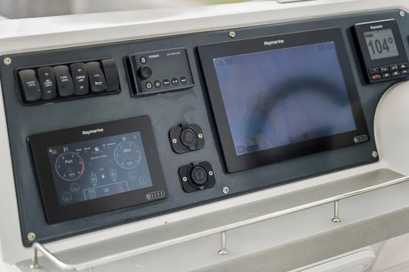 Slide: The Image of Control panel of a 2021 Leopard 43 Powercat featuring Raymarine navigation displays. - 14