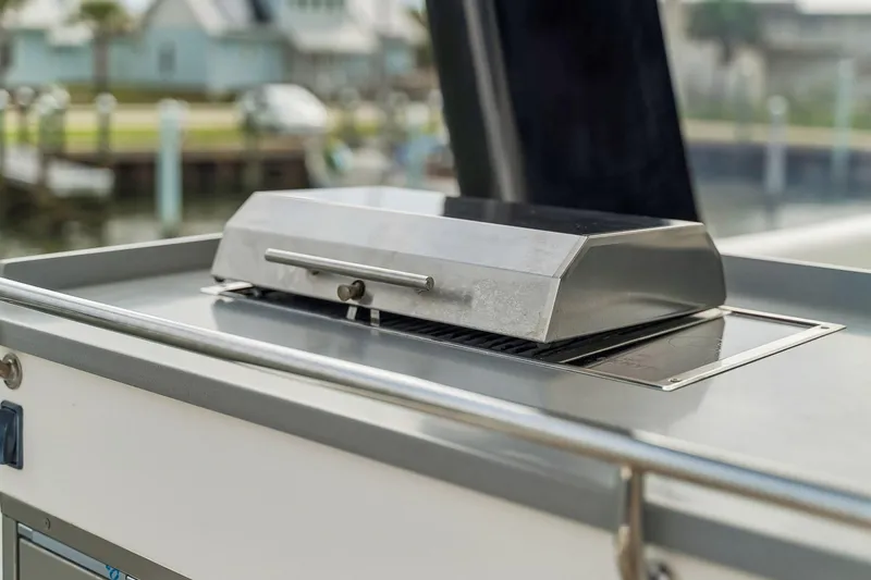 Slide: The Image of Outdoor grill on 2021 Leopard 43 Powercat yacht, docked near waterfront homes. - 18