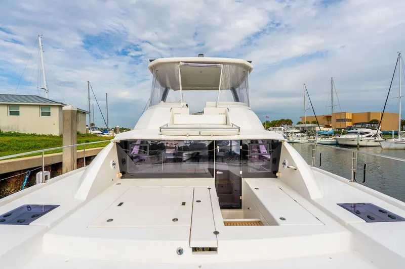 Slide: The Image of 2021 Leopard 43 Powercat yacht docked at marina, showcasing spacious deck and modern design. - 9
