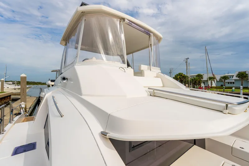 Slide: The Image of 2021 Leopard 43 Powercat yacht docked at marina under cloudy sky. - 6