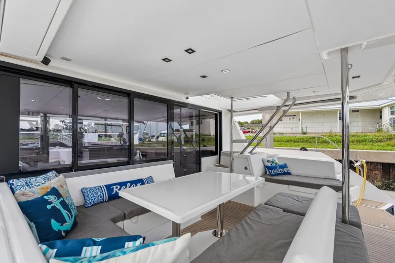 Slide: The Image of 2021 Leopard 43 Powercat yacht interior with modern seating and decorative pillows. - 23
