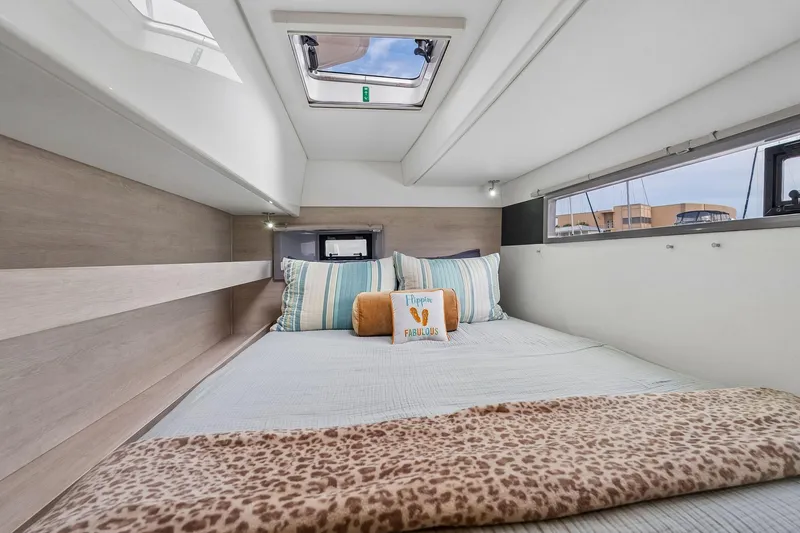 Slide: The Image of Cozy bedroom interior of 2021 Leopard 43 Powercat with skylight and decorative pillows. - 42