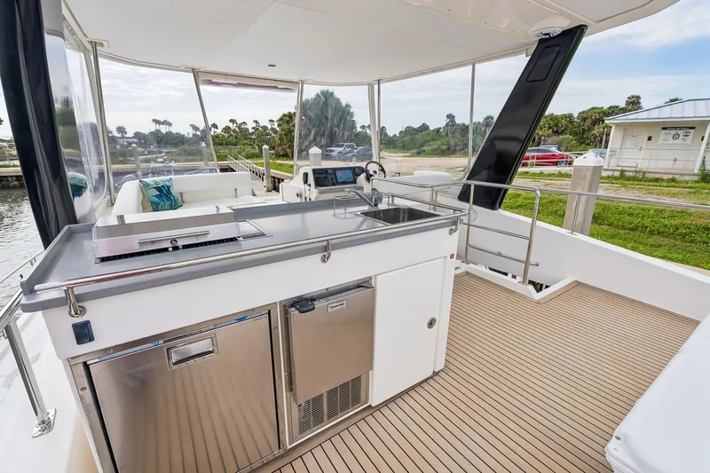 Slide: The Image of Outdoor kitchen on 2021 Leopard 43 Powercat yacht with stainless steel appliances and scenic view. - 17