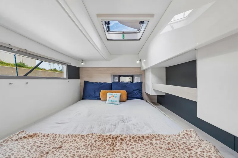 Slide: The Image of Cozy bedroom interior of 2021 Leopard 43 Powercat with skylight and plush bedding. - 36