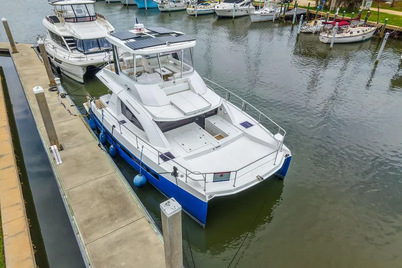 Slide: The Image of 2021 Leopard 43 Powercat docked at marina, showcasing sleek design and spacious deck. - 45