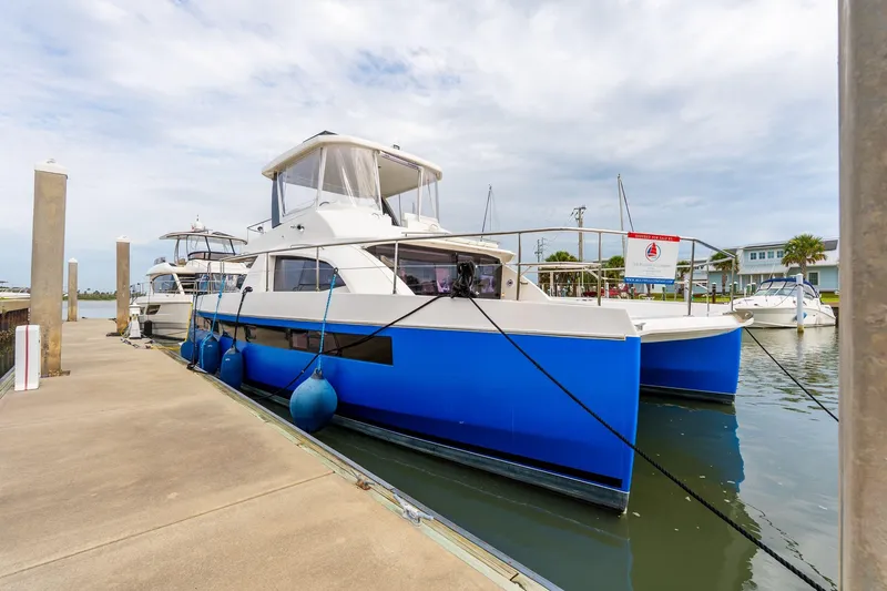 The Image of 2021 Leopard 43 Powercat docked at marina, featuring sleek blue and white design. - 0