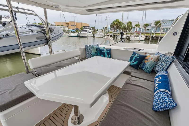 Slide: The Image of Leopard 43 Powercat 2021 yacht interior with cushioned seating and decorative pillows. - 22