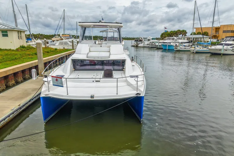 Slide: The Image of 2021 Leopard 43 Powercat docked in a marina, surrounded by other boats. - 49