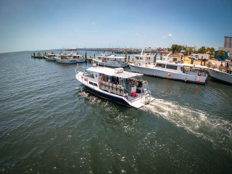 Slide: The Image of A Newton 36' Dive Special boat navigates through a busy harbor with several other boats. - 2