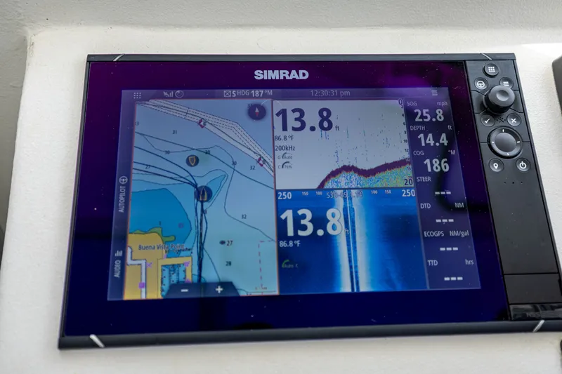 Slide: The Image of Simrad navigation system on a boat displaying chart and sonar readings. - 30