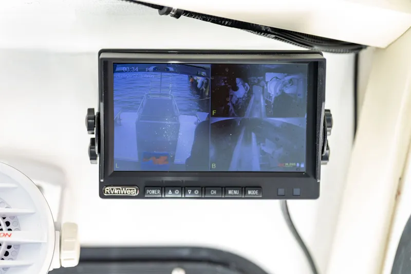 Slide: The Image of A surveillance monitor displays four camera views on a boat. - 27