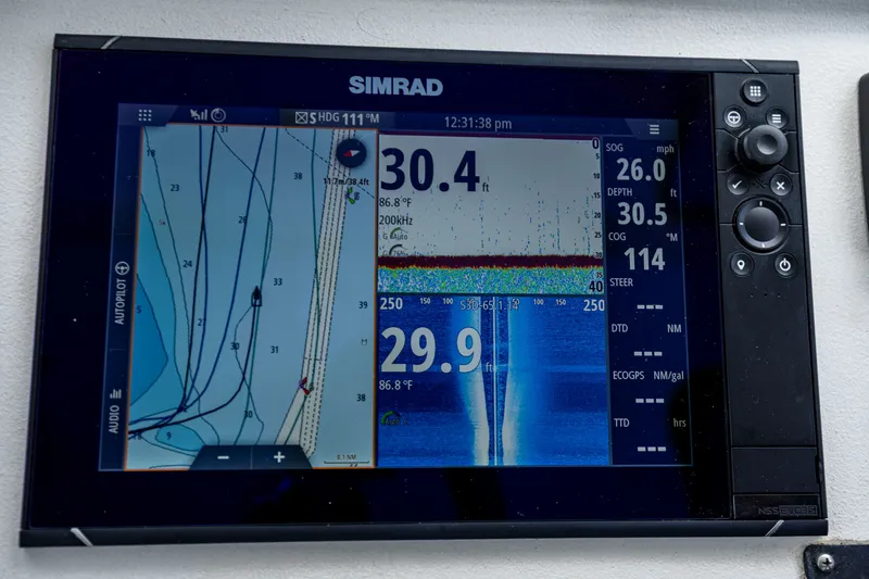 Slide: The Image of Simrad navigation system on a boat displaying depth and course information. - 31