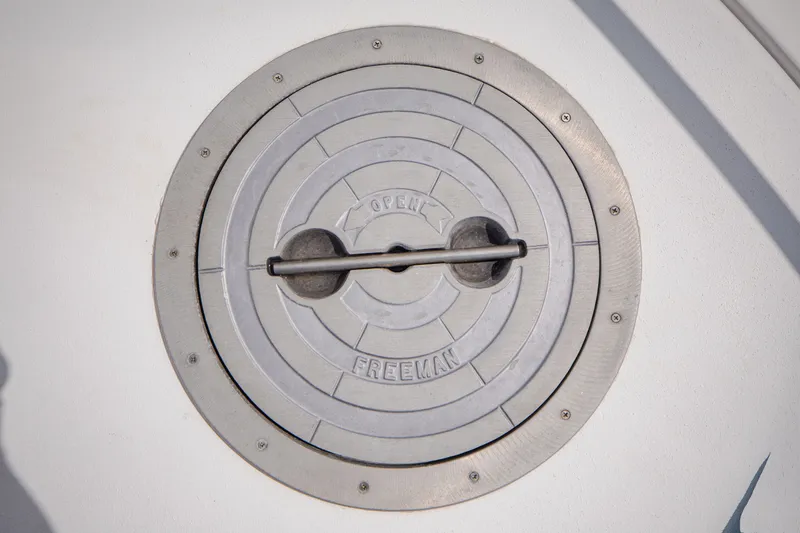 Slide: The Image of Round metal access hatch on a boat, labeled "OPEN" and "FREEMAN." - 9