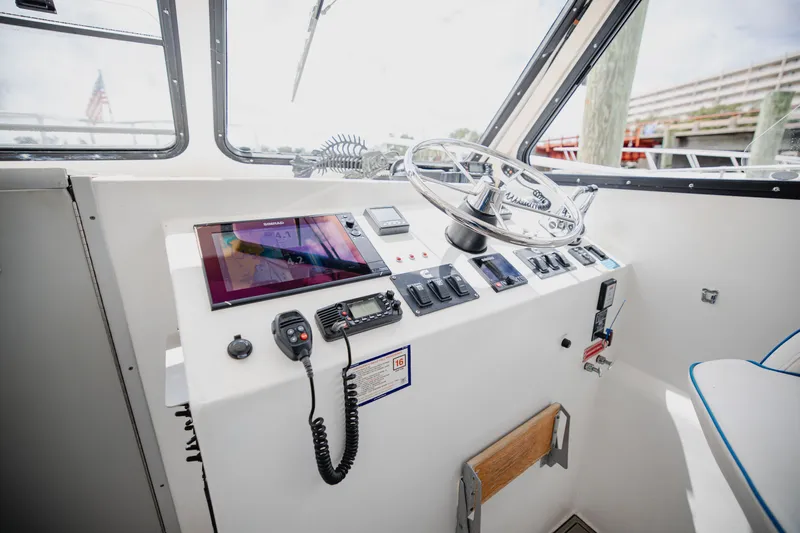 Slide: The Image of The helm of a 2019 Newton 36' Dive Special with modern electronics and controls. - 13