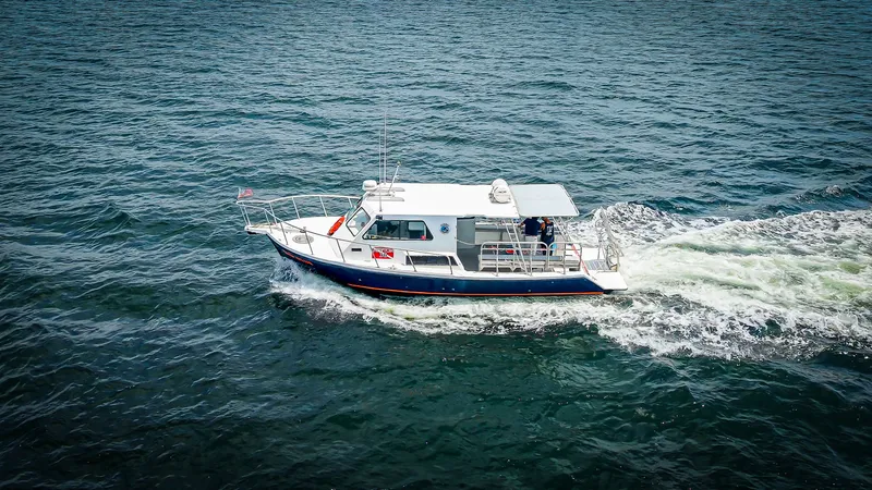 Slide: The Image of A 2019 Newton 36' Dive Special boat cruising on the water. - 5