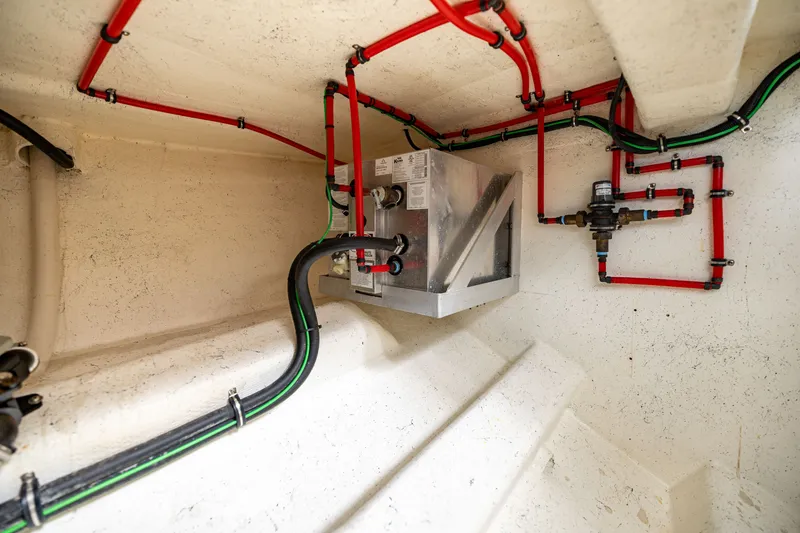 Slide: The Image of A clean engine room with colored pipes and a metal box. - 39