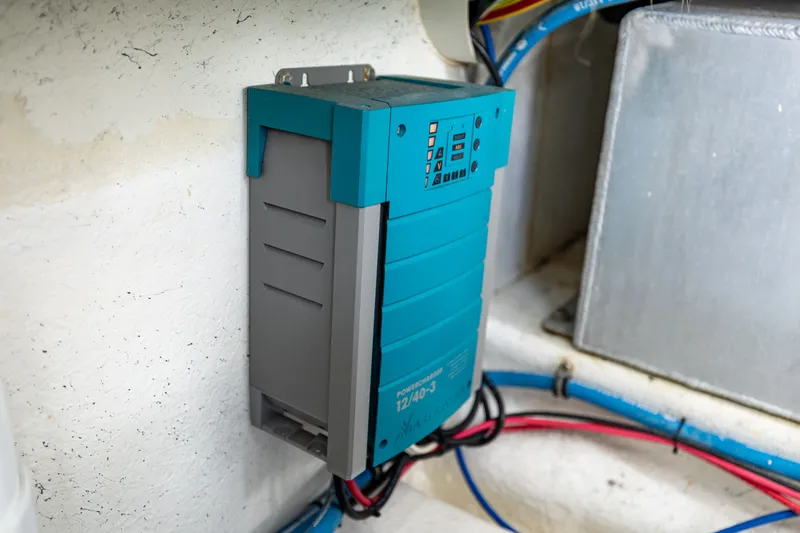 Slide: The Image of An electrical device is mounted on a boat wall, surrounded by cables. - 36