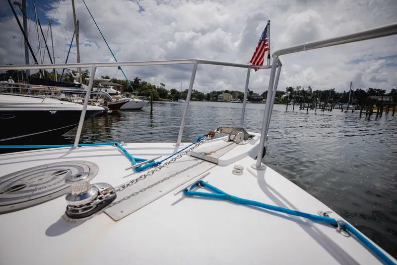 Slide: The Image of The boat is on the water, with an American flag at the stern. - 10