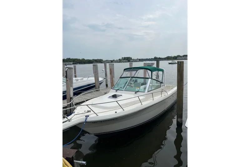 Slide: The Image of 2000 Pursuit 2860 Denali boat docked at a marina on a calm day. - 4