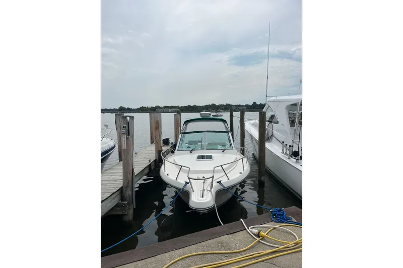 Slide: The Image of 2000 Pursuit 2860 Denali boat docked at marina, front view. - 3
