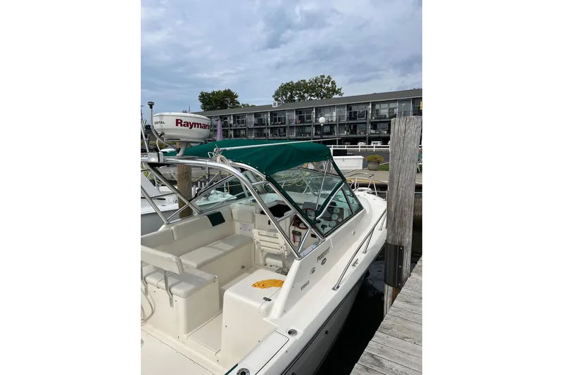 Slide: The Image of 2000 Pursuit 2860 Denali boat docked at marina with green canopy. - 6