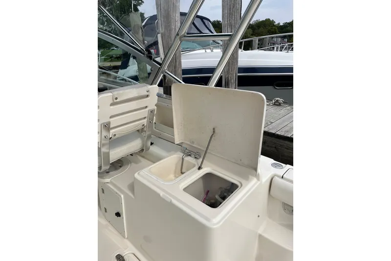 Slide: The Image of 2000 Pursuit 2860 Denali boat interior with open storage compartment. - 11