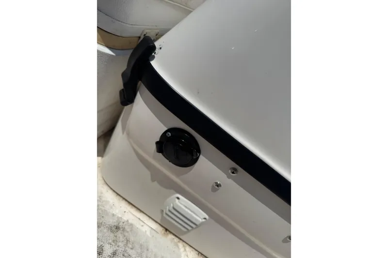 Slide: The Image of Close-up of a 2018 Edgewater 158CS boat's white interior with a black latch. - 13