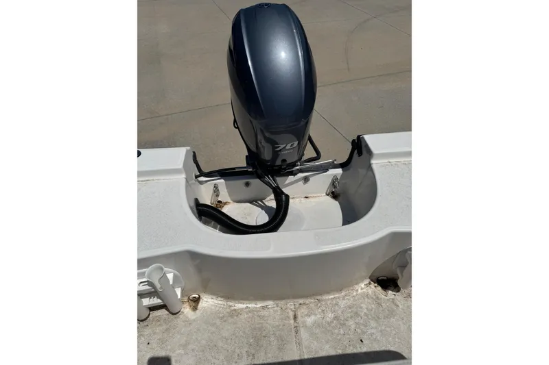 Slide: The Image of 2018 Edgewater 158CS boat with a 70 horsepower outboard motor, viewed from the rear. - 12