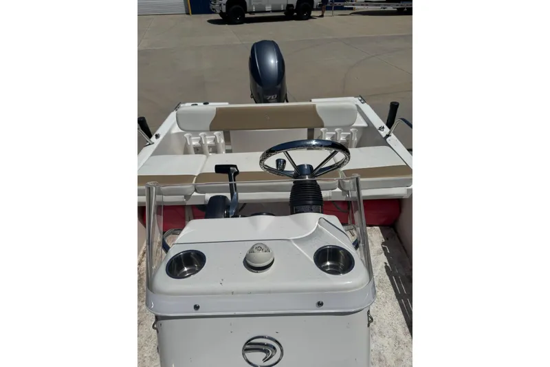 Slide: The Image of 2018 Edgewater 158CS boat interior with steering wheel and seating area. - 9