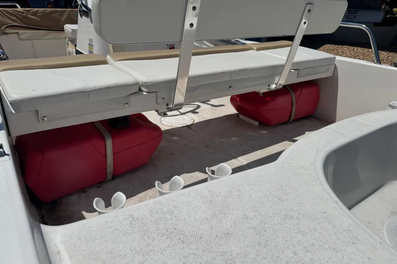 Slide: The Image of 2018 Edgewater 158CS boat interior with red fuel tanks and white seating. - 3