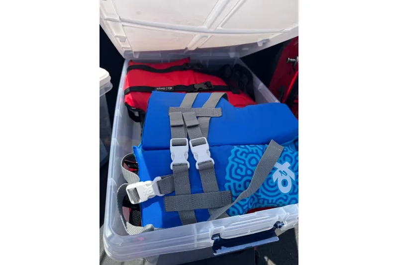 Slide: The Image of Plastic storage box with blue and red life jackets on an Edgewater 158CS boat, 2018 model. - 15
