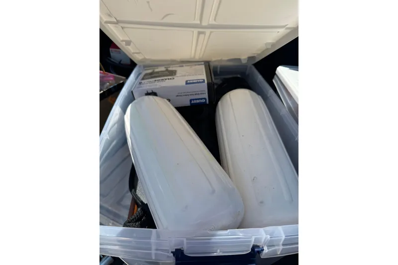 Slide: The Image of Open storage box with white boat fenders and a packaged item, Edgewater 158CS 2018. - 16