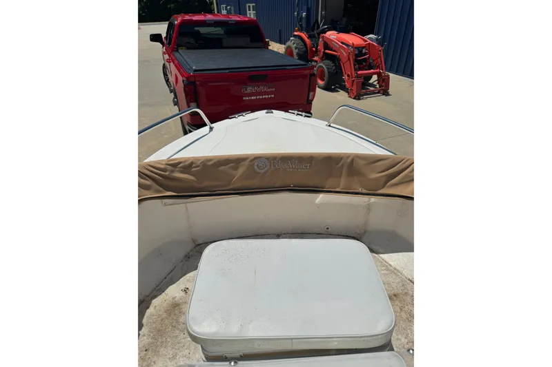 Slide: The Image of 2018 Edgewater 158CS boat with red GMC Sierra and orange tractor in background. - 7