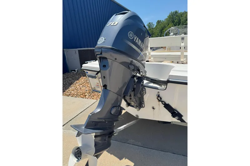 Slide: The Image of 2018 Edgewater 158CS boat with Yamaha 70HP outboard motor, docked outdoors. - 5
