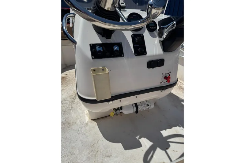 Slide: The Image of Edgewater 158CS 2018 boat console with steering wheel and controls. - 4