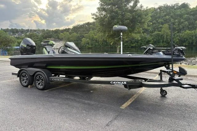 Slide: The Image of 2023 Caymas CX 20 PRO boat on trailer, parked near a scenic lake. - 1